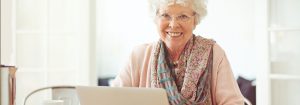 Senior Woman at Computer Smiling
